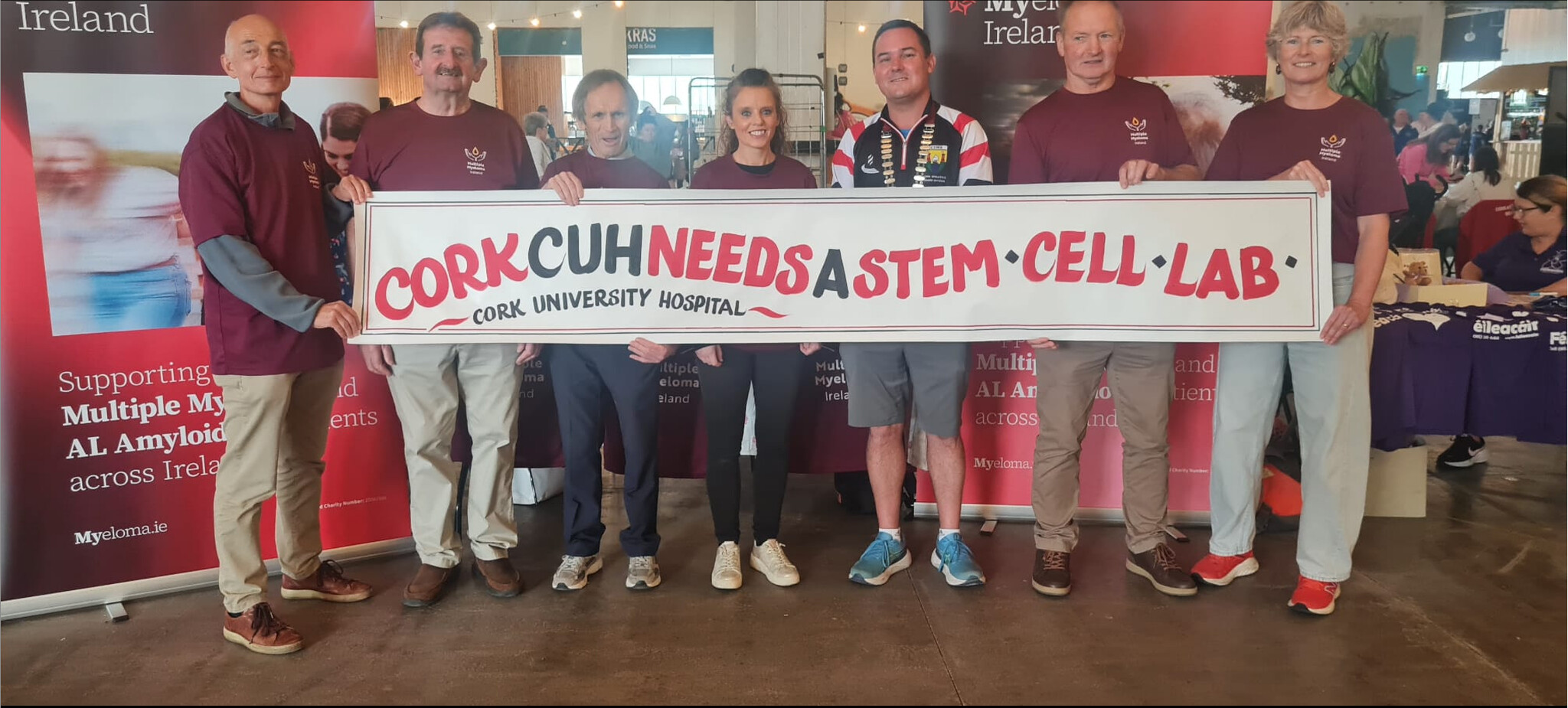 Community supporters holding a Cork University Hospital stem cell campaign banner